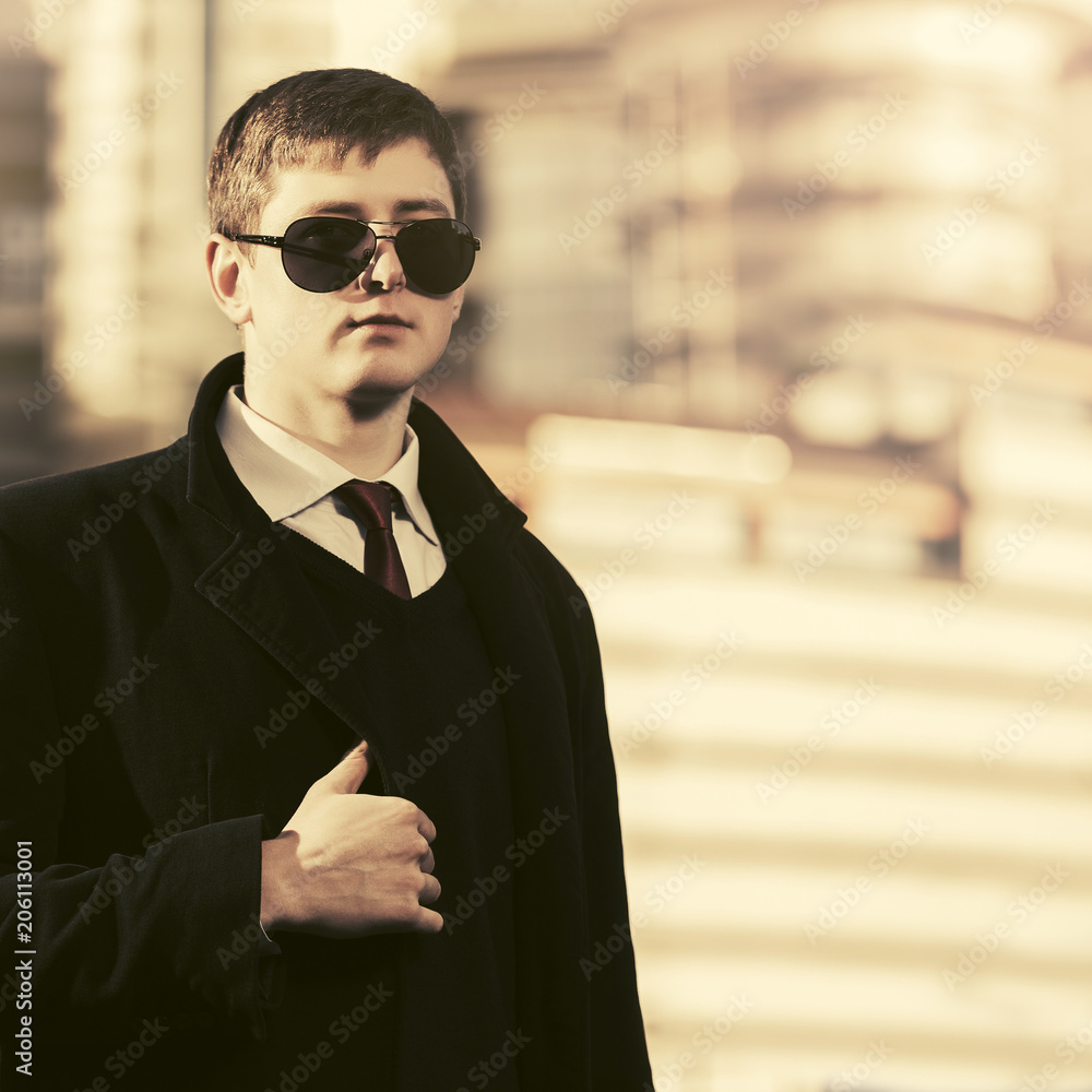 Young handsome business man walking in city street Young handsome business man walking in city street