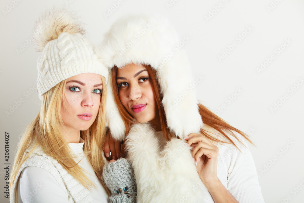 Two ladies in winter white outfit. Two ladies in winter white outfit.