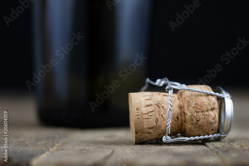 Cork from champagne on a wooden kitchen table. Good New Year's drinks and great fun.