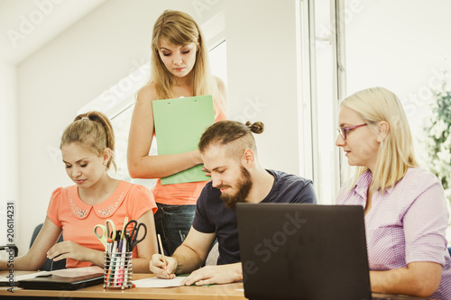 Students and teacher tutor in classroom