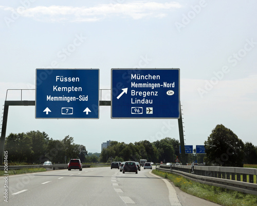 Traffic signs with directions to the city and the state borders