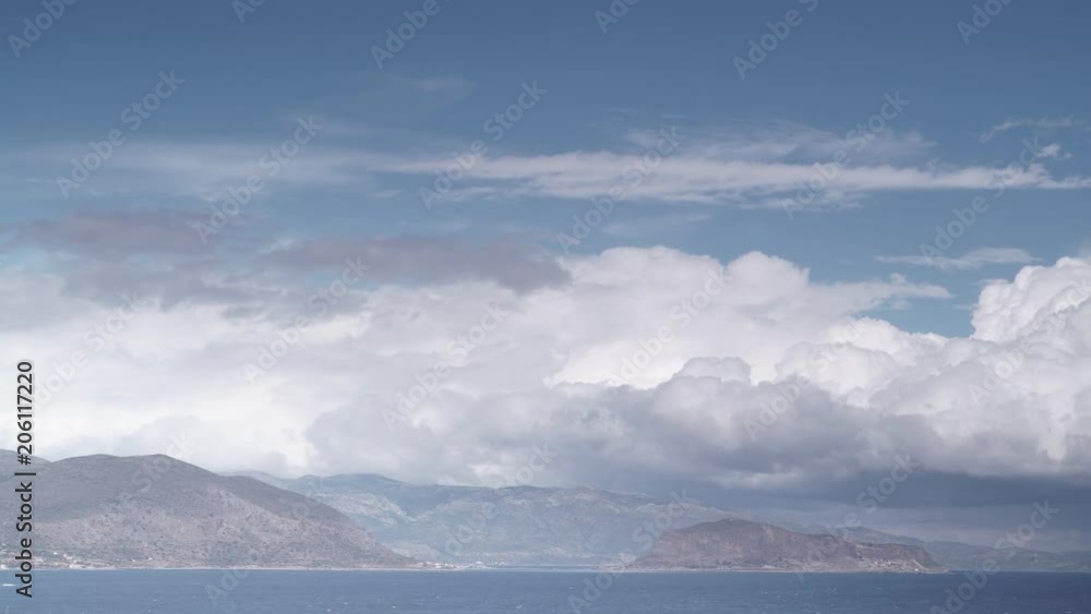Greek island Monemvasia and cloudy sky, view from distance. Greece Peloponnese Lakonia, Time lapse Greek island Monemvasia and cloudy sky, view from distance. Greece Peloponnese Lakonia, Time lapse