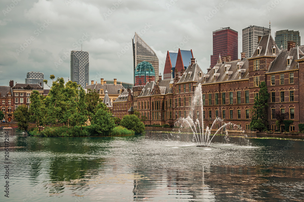 Hofvijver lake with the Binnenhof (Gothic government buildings) and skyscrapers in The Hague. Important political center, is a mix of historic city with modernity. Western Netherlands.