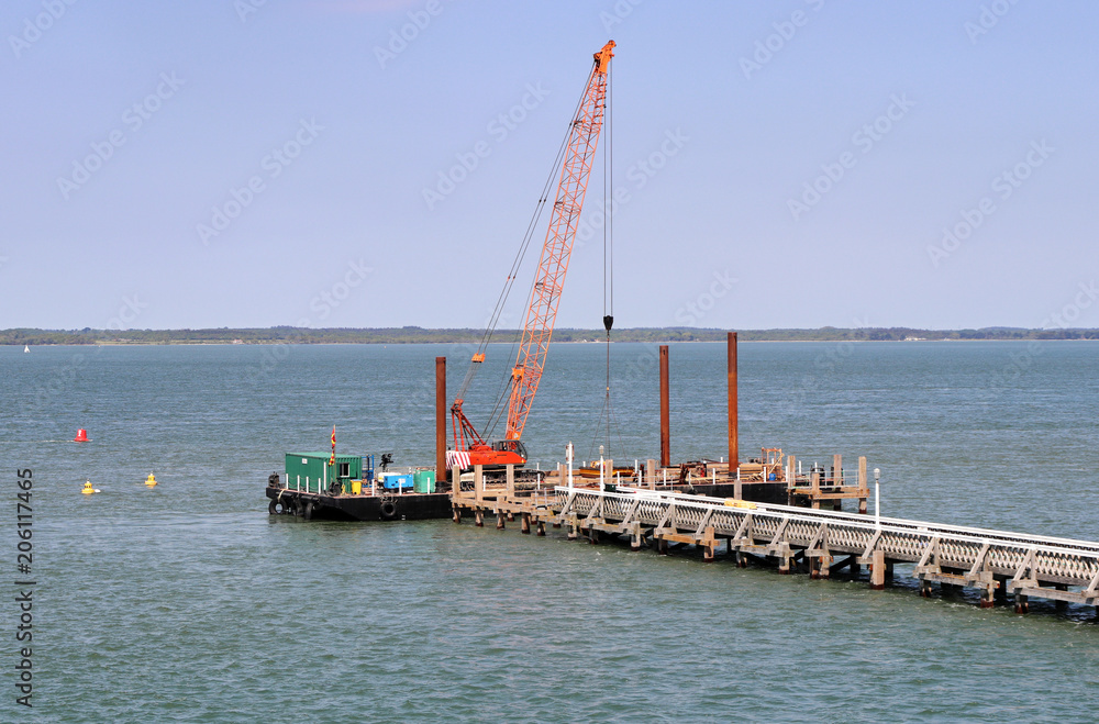 Crane on floating platform constructing a Jetty on the sea