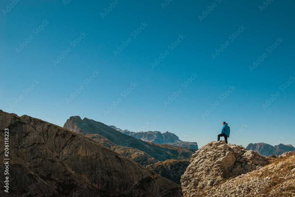 young man watching the beauty of nature in south tyrol, rifugio lagazuio, passo falzarego, italien dolomites
