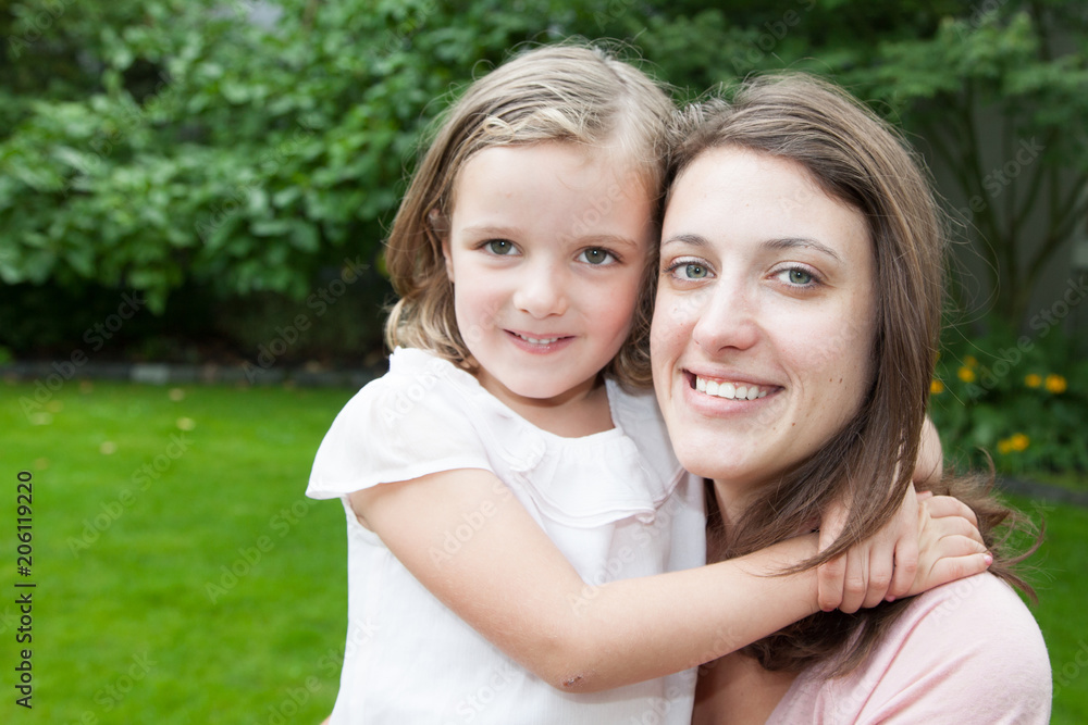 Lifestyle portrait mom and daughter in happines at the outside in the meadow Lifestyle portrait mom and daughter in happines at the outside in the meadow