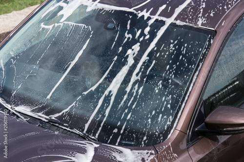 Car front window with washing foam