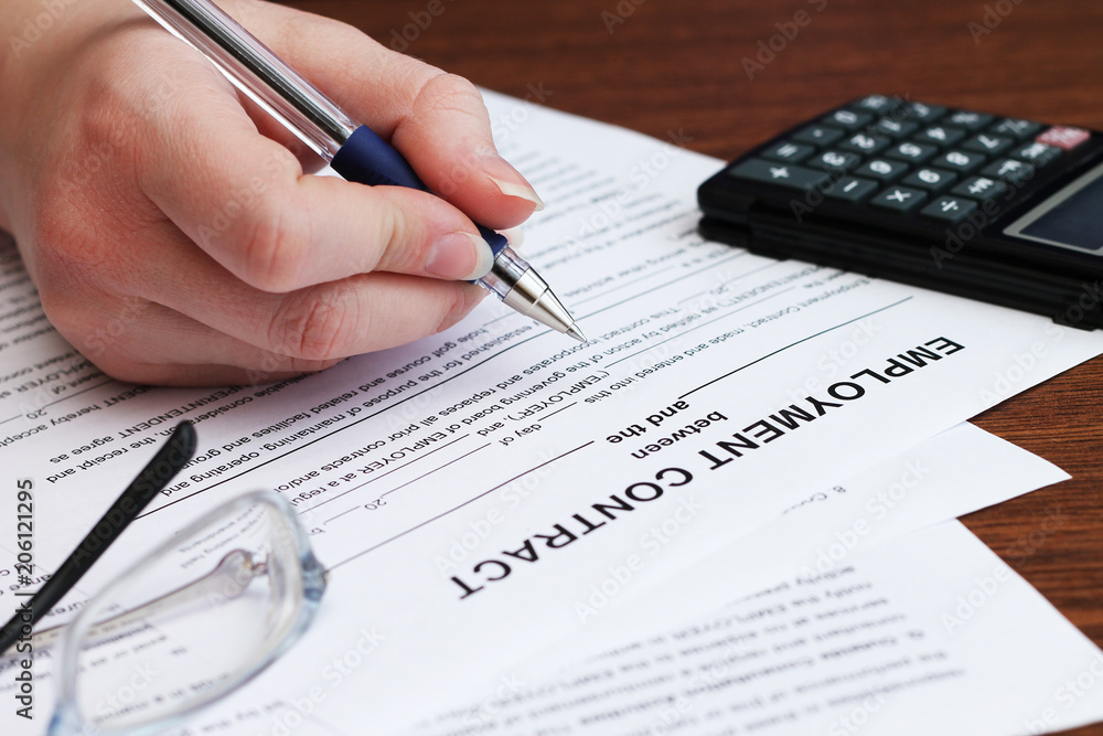 Image of employee signs employment contract, close-up Image of employee signs employment contract, close-up