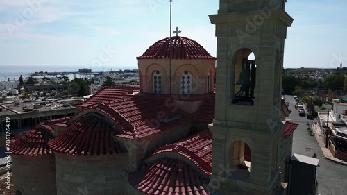 A beautiful view of the Pafos embankment, a quadrocopter flight through the Greek church. A bird flies by.