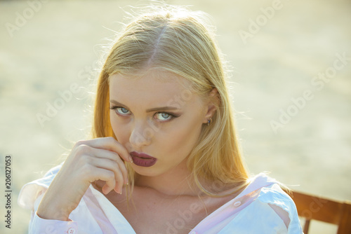 Girl with sensual lips, makeup face and long blond hair