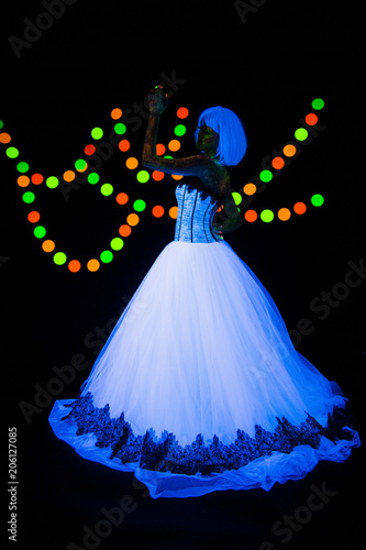 Wedding photo session of young bride Neon photography bright colorful on a dark background in ultraviolet rays young girl in white wedding dress posing in vogue style