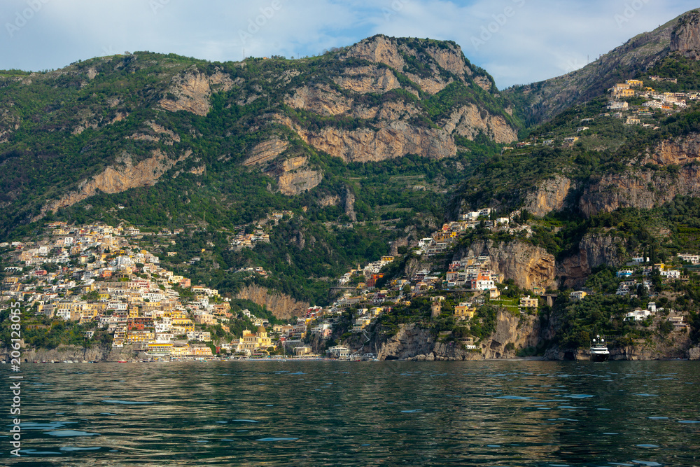 The beautiful Village of Positano at the Italian Amalfi Coast seen from the turquoise Sea on a sunny Morning