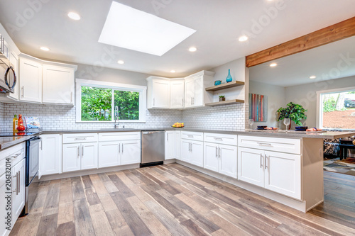 Open concept kitchen equipped with skylight.