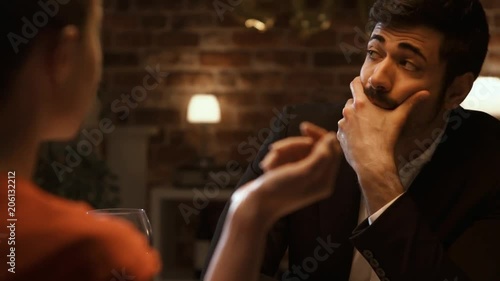 Bored man dining with a talkative chatty woman