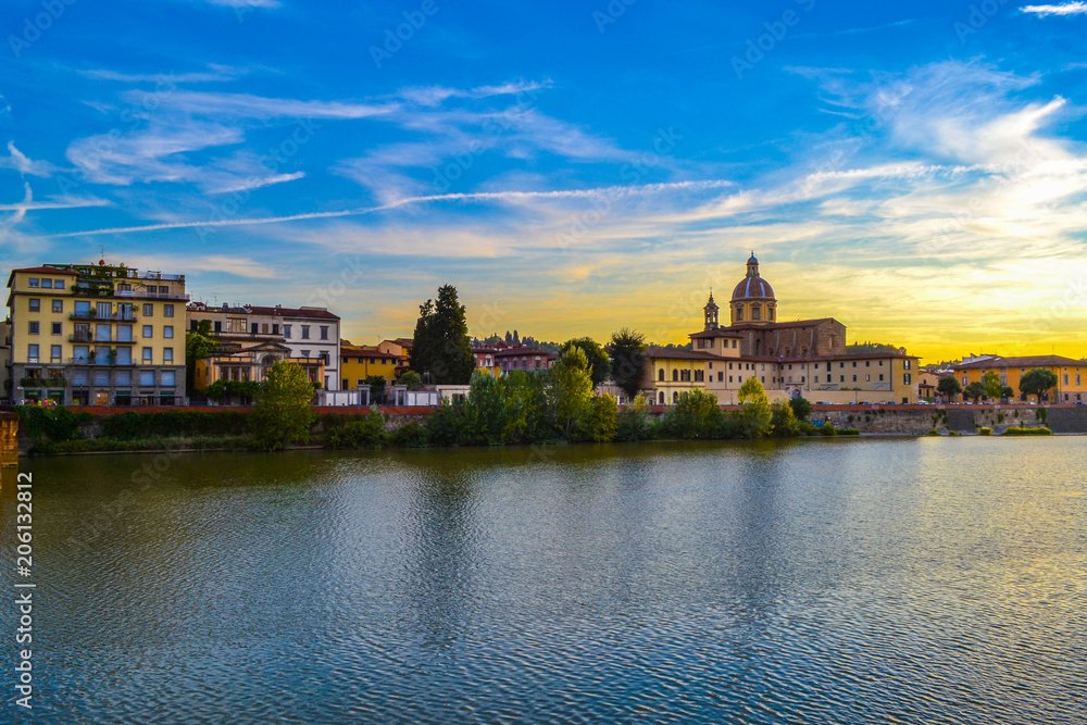 Sunset in Arno river with San Frediano in Cestello (Church of Saint Fridianus) at the background, in Florence, Italy.