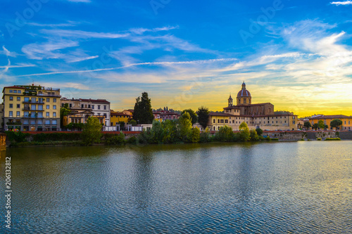 Sunset in Arno river with San Frediano in Cestello (Church of Saint Fridianus) at the background, in Florence, Italy.