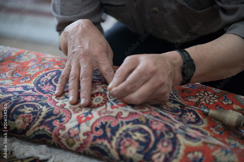 Fototapeta premium Man repairing a carpet