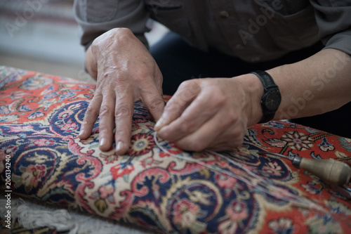 Man repairing a carpet