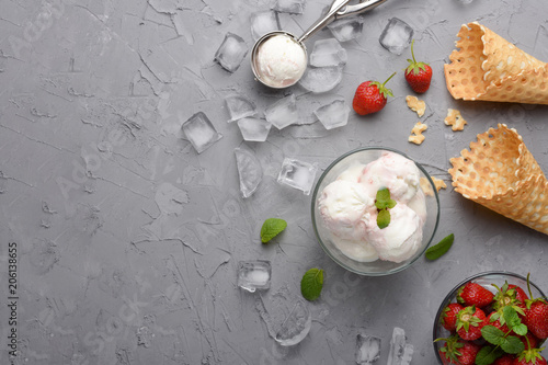 Strawberry ice cream with waffle cone, and strawberries and a spoon for ice cream. With empty space for writing