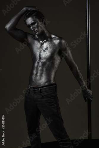 Macho with naked chest, athlete, sportsman hold metallic pole.