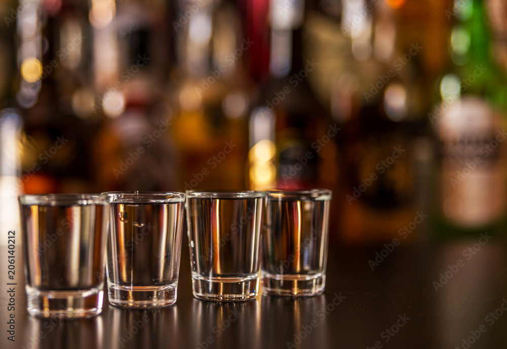 Traditional pure vodka in glasses on a black background, chilled drink