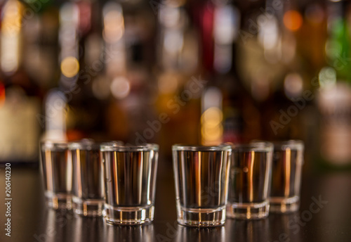 Traditional pure vodka in glasses on a black background, chilled drink © Q77photo