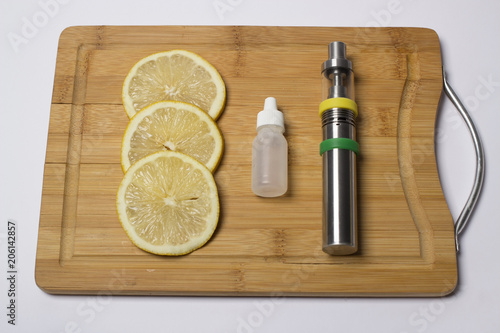 Vaping device with lemon on kitchen board photo