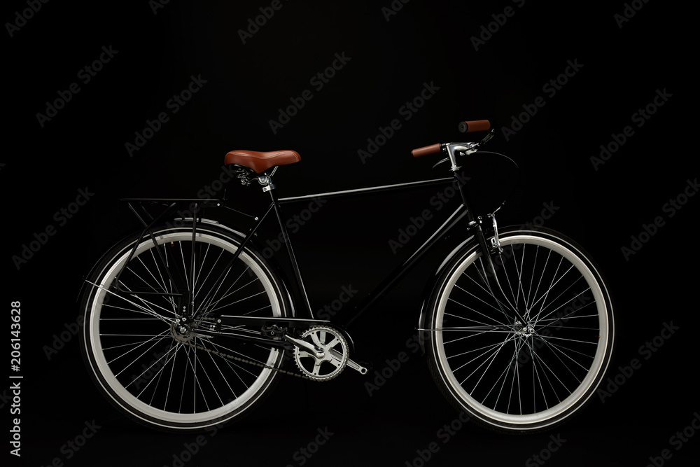 Fototapeta side view of classic vintage bicycle isolated on black