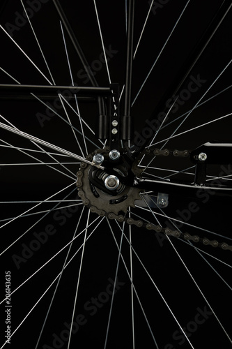 detail of bicycle wheel isolated on black, close-up view