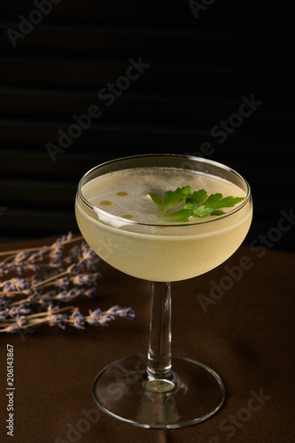 Petrucho cocktail drink on bar table in restaurant. Freshness drink with Parsley Infused, Cacao white, Lawanda bitter, Lemon juice, Simple syrup Parsley
