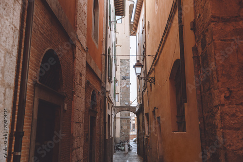 narrow alley between buildings in old city  Pisa  Italy