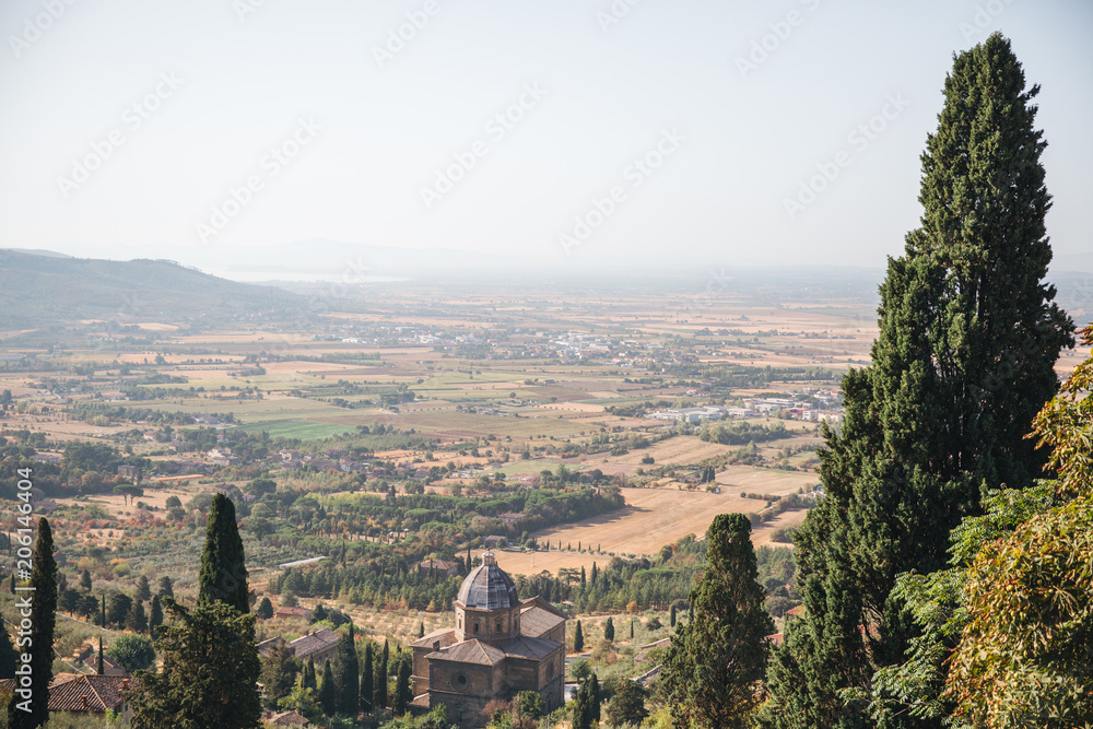 scenic view of Tuscany region with fields and green trees around, Italy