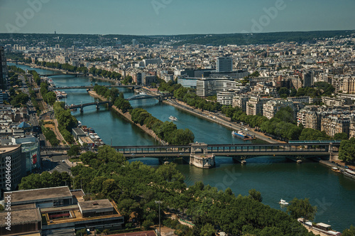Skyline, River Seine bridges and buildings under blue sky, seen from the Eiffel Tower in Paris. Known as the “City of Light”, is one of the most impressive world’s cultural center. Northern France.