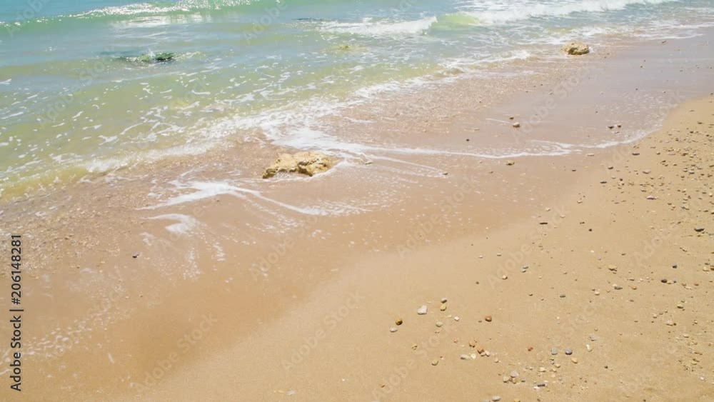 Soft blue ocean waves crashing on the sandy beach. Soft blue ocean waves crashing on the sandy beach.