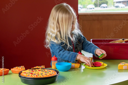 Little girl playing with pretend food