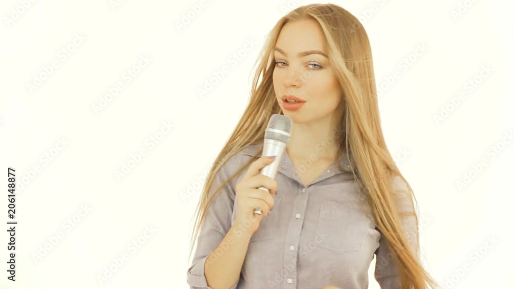 Pretty young girl with a microphone, isolated Pretty young girl with a microphone, isolated