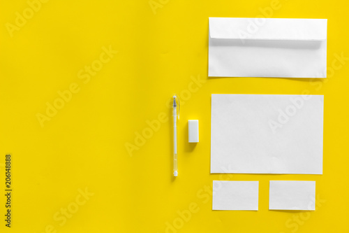 Blank stationery for branding on yellow background top view mockup pattern space for text