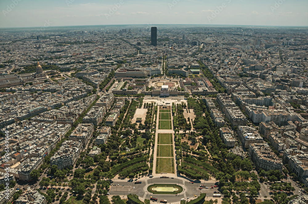 Skyline, Champ de Mars Park and buildings under blue sky, seen from the Eiffel Tower top in Paris. Known as the “City of Light”, is one of the most impressive world’s cultural center. Northern France.