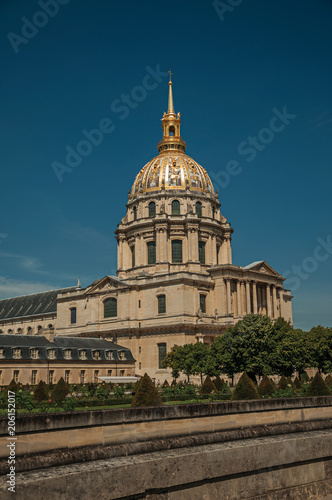 Trees in the gardens of Les Invalides Palace with the golden dome in a sunny day at Paris. Known as the “City of Light”, is one of the most impressive world’s cultural center. Northern France. © Celli07