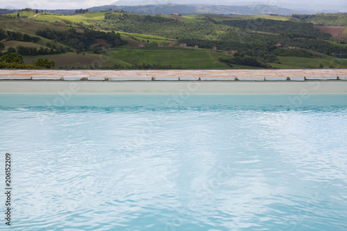 swimming pool against beautiful landscape in Tuscany