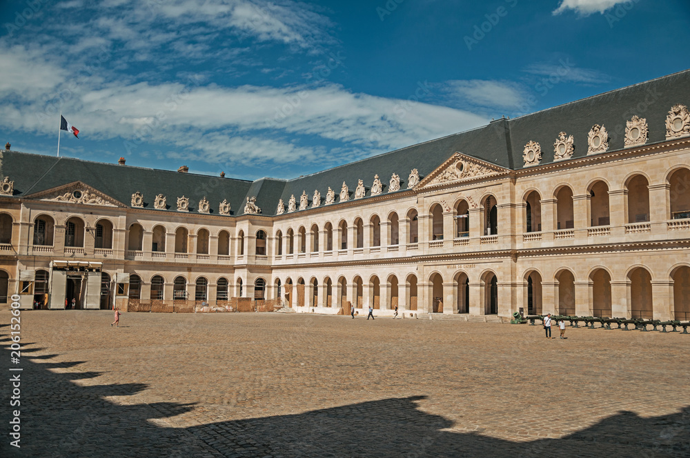 View of the inner courtyard of the Les Invalides Palace with old cannons in a sunny day at Paris. Known as the “City of Light”, is one of the most impressive world’s cultural center. Northern France.