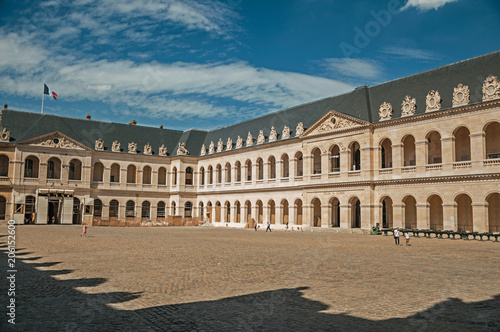View of the inner courtyard of the Les Invalides Palace with old cannons in a sunny day at Paris. Known as the    City of Light     is one of the most impressive world   s cultural center. Northern France.