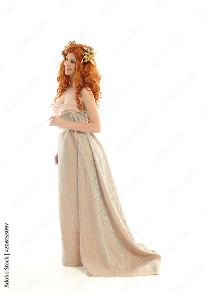 full length portrait of pretty red haired lady wearing fantasy toga gown, standing pose on white background.