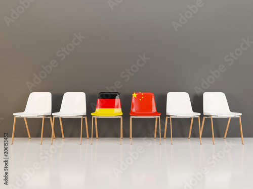Chairs with flag of Germany and china in a row photo