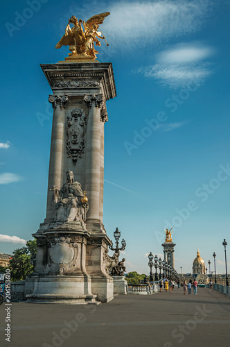 Marble column with golden statue adorning the Alexandre III bridge over the Seine River in Paris. Known as the “City of Light”, is one of the most impressive world’s cultural center. Northern France. © Celli07