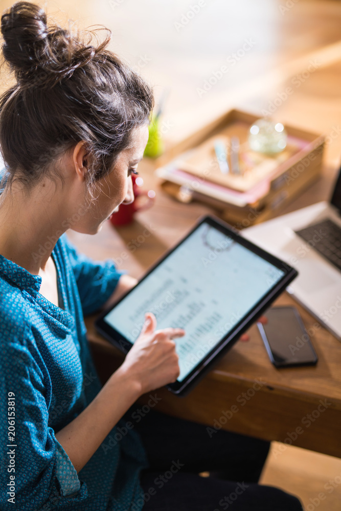 View from above. A woman using a digital tablet View from above. A woman using a digital tablet