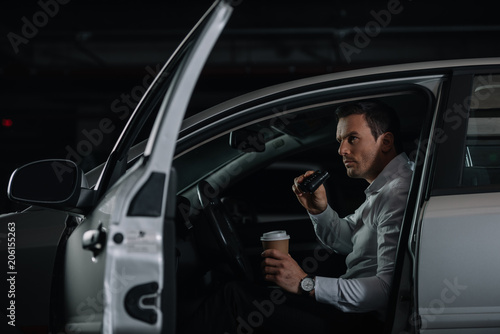 undercover male agent with cup of coffee doing surveillance by binoculars from car © LIGHTFIELD STUDIOS