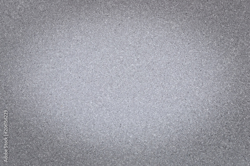 Texture of granite gray color with small dots, with vignetting, use background.
