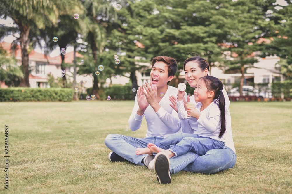Family Concept. Happy male and female playing with children outside. Family is doing happy activities at Playground. Parents are playing happily. Family Concept. Happy male and female playing with children outside. Family is doing happy activities at Playground. Parents are playing happily.