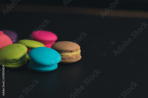 Macaroons on dark background, colorful french cookies macaroons.